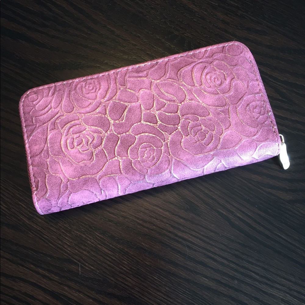 Metallic frame wallet with embossed rose design.